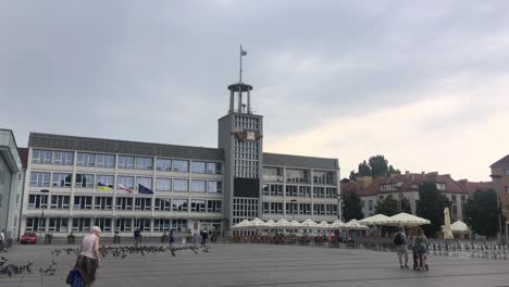 Koszalin-town-hall-in-Poland-in-cloudy-weather-with-people-walking