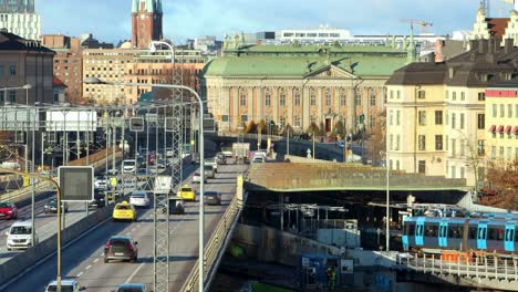 Subway-trains-and-car-traffic-on-bridge-in-central-Stockholm,-Sweden