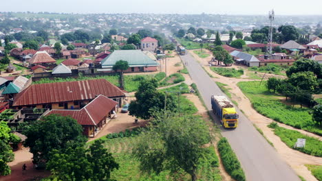 Gboko,-Nigeria-highway-in-Benue-State-in-a-rural-neighborhood---pullback-rising-aerial