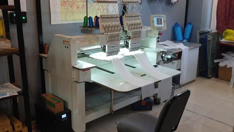 View-of-fashion-technology-with-computerized-embroidery-machine-embroidering-pattern-from-software-design-onto-clothing-and-textiles