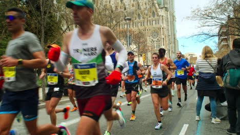 Barcelona-Marathon-2024-Diversity,-Inclusivity-and-Community-Participation-near-Sagrada-Familia-in-slow-motion