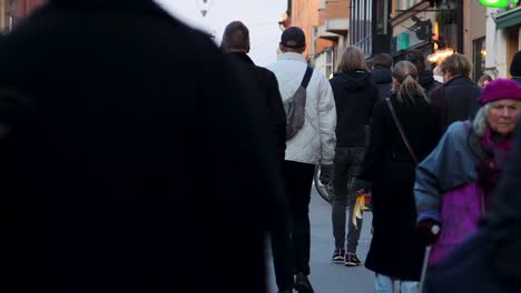 Close-slomo-of-crowd-moving-on-pedestrian-shopping-street-in-Stockholm