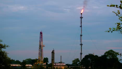 Wide-angle-view-of-fire-on-oil-plant-chimney-during-evening