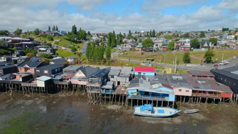 Drone-Flyover-Panning-Over-Famous-Colorful-Stilt-Homes,-Castro-Chiloe-Island,-4K-Chile