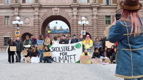 Kid-takes-photo-of-Fridays-for-Future-protesters-by-Swedish-Parliament