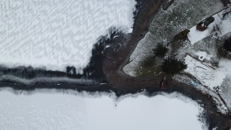 Aerial-view-of-a-frozen-lake-and-snow-covered-landscape-in-Poland