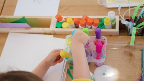 Little-Child-Drip-Painting-Holding-Dropper-and-Sucks-in-Colored-Water-into-Pipette-From-Containers---Hands-Close-up