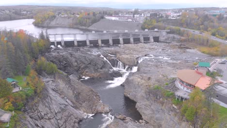 High-flying-aerial-shot-of-the-Grand-Falls-located-in-New-Brunswick-on-a-sunny-day-as-the-camera-descends-towards-the-river