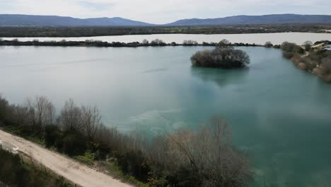 Sunlight-glistens-on-water-reflecting-overcast-sky-in-silty-ancient-Antela-lagoon-Areeiras-da-Limia-in-Xinzo-de-Limia-Ourense-Galicia-Spain