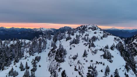 Scenic-Snowy-Mountain-and-Tree-Landscape,-Colorful-Sunset-Sky