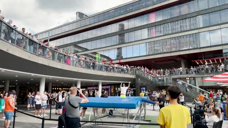 Young-man-jumps-and-spins-around-at-trampoline-show-on-city-square