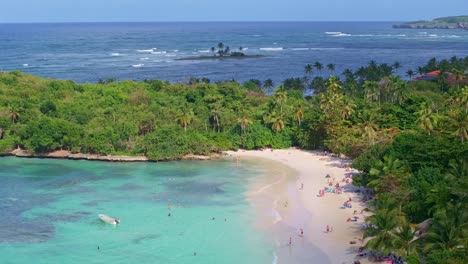 Many-people-at-Playa-La-Playita-beach-at-Las-Galeras-in-Samana-peninsula,-Dominican-Republic