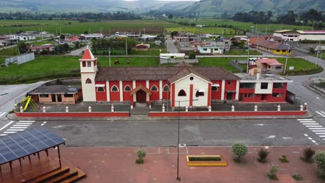Sideways-moving-clip-of-a-drone-along-the-central-church-of-the-Chaupi-parish,-Pichincha-province,-Ecuador