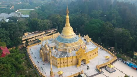 Aerial-drone-of-Buddhist-temple-with-golden-pagoda-Lumbini-Natural-Park-or-Taman-Alam-Lumbini-in-Desa-Dolat-Rayat,-Berastagi-in-North-Sumatra,-Indonesia