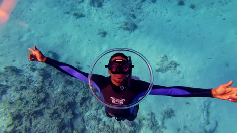 Young-man-snorkeling-with-a-bubble-ring,-doing-tricks