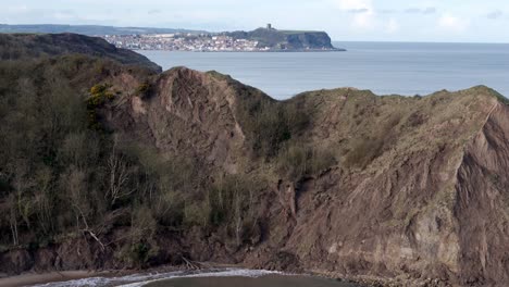 Aerial-tracking-footage-of-North-Yorkshire-coastline-with-Scarborough-town-in-the-distance