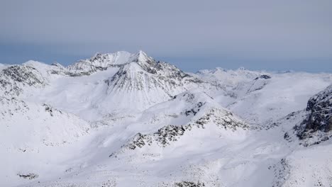 Landscape-of-Beautiful-Snowy-White-Winter-Mountain-Peaks-AERIAL
