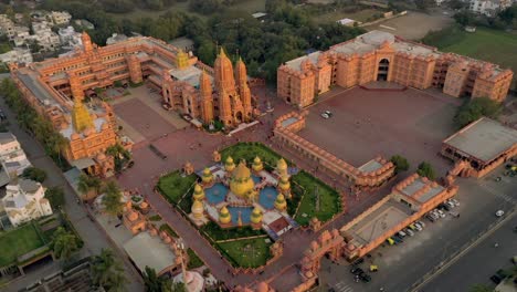 Aerial-drone-view-camera-is-running-behind-there-are-lots-of-houses-behind-the-temple-and-a-grand-very-beautiful-looking-temple