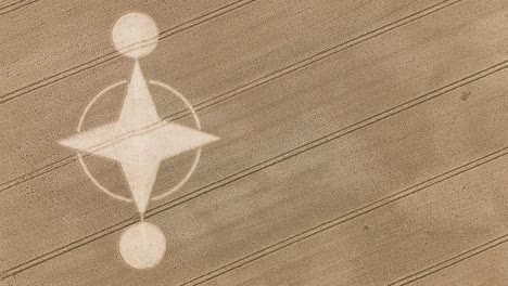 Mysterious-shape-of-crop-circle-in-brown-farm-land,-Preston-Candover