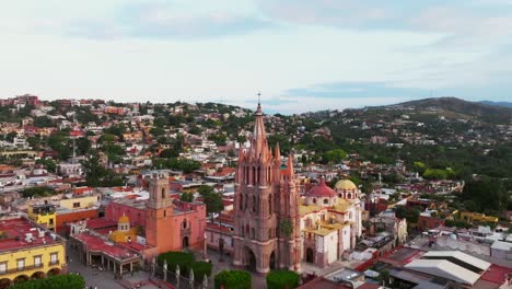 órbita-Diurna-Sobre-El-Cielo-Azul,-La-Colorida-Parroquia-De-San-Miguel-Arcángel-Y-El-Centro-De-La-Ciudad-De-San-Miguel-De-Allende