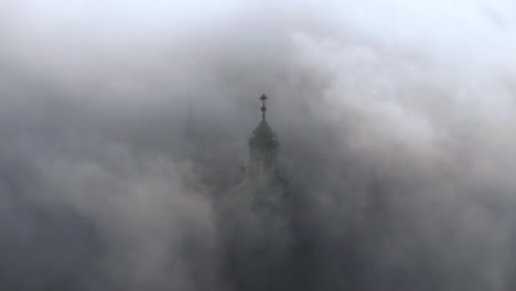 Aerial-view-of-Wawel-Castle-during-foggy-sunrise,-Krakow,-Poland