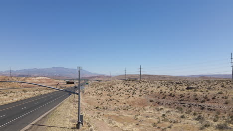 Aerial-View-of-Welcome-to-Utah-Road-Sign-by-Veterans-Memorial-Highway-on-Nevada-Border,-Drone-Shot