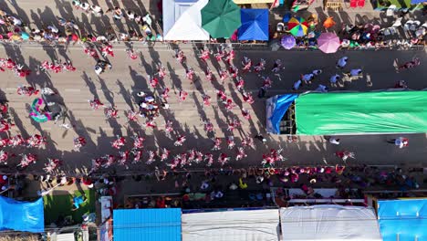 Top-down-rising-from-silver-sparkling-costumes-and-dancers-playing-in-street-for-Carnaval-Grand-March