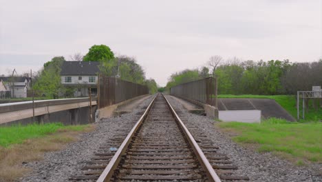 Establishing-shot-pushing-forward-on-train-tracks