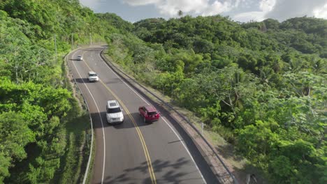 Aerial-of-Car-Driving-in-Tropical-Forest-Road-Dominican-Republic,-Slowmotion