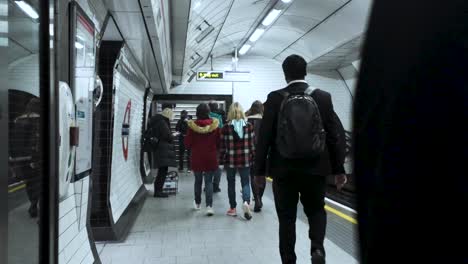 Commuters-Making-Their-Way-Towards-Exit-Along-London-Underground-Station-Platform