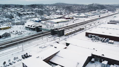 European-Route-E45-And-Train-Station-With-Snow-covered-Surroundings-In-Winter