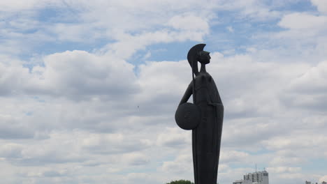The-Bronze-Goddess-Minerva-Statue-Stands-Against-a-Backdrop-of-Stratus-Clouds-in-Antwerp,-Belgium---Medium-Shot