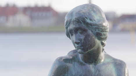 Telephoto-shot-on-face-of-The-Little-Mermaid-in-Copenhagen,-Denmark