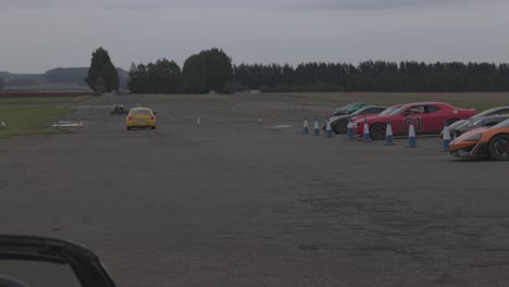 Static-shot-of-supercars-racing-around-a-Scottish-racetrack-from-the-pit-lane