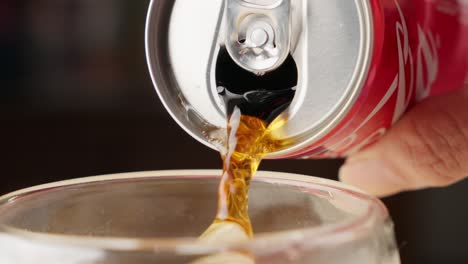 Pouring-Soft-Drink-From-Coca-Cola-Can-Into-Glass,-Close-Up-Of-Soda-Brand