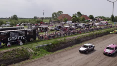 Aerial-view-of-old-cars-racing-on-dirt-track,-Friesland,-Netherlands