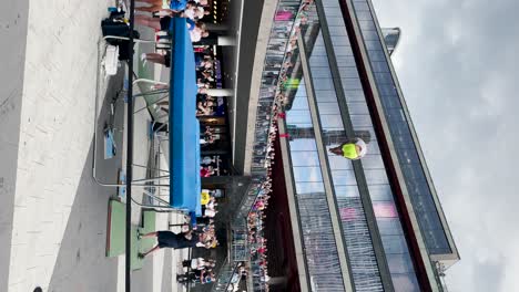 Man-jumps-and-does-amazing-tricks-on-trampoline-in-Stockholm,-vertical