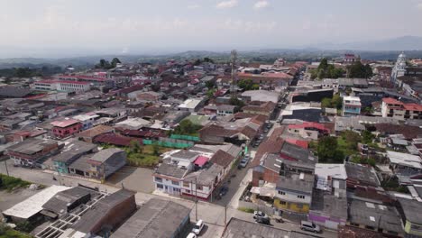 Aerial-orbit-over-simple-houses-in-Filandia,-Colombia,-small-town-in-the-Andes