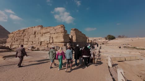 Tourists-walk-to-the-entrance-of-ruins-of-Sphinx-Temple