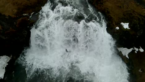 4K-drone-capturing-cinematic-views-of-water-cascading-down-the-mountains-in-Iceland-from-an-aerial-perspective