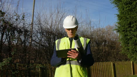 A-mature-professional-architect-with-a-tablet-inspecting-a-construction-building-site