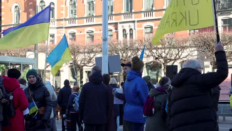 People-with-Ukrainian-flags-at-anti-war-rally-in-Stockholm,-Sweden