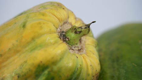 Close-up-Slow-zoom-in-to-a-ripe-yellow-papaya-with-spots-on-it-vegan-vegetarian-fruit-paw-paw