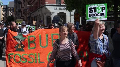 Protesters-with-signs-and-banners-march-at-environment-rally,-slomo