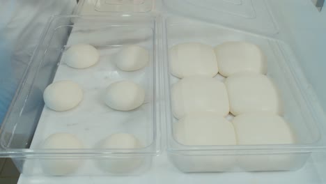 Chef-showcase-two-storage-tray-of-pizza-dough-before-and-after-overnight-fermentation