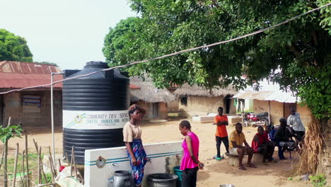 Potable-water-station-at-a-village-in-Pila,-Nigeria---rising-aerial