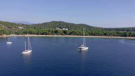 Aerial:-Beautiful-organised-sandy-beach-Koukounaries,-Skiathos-island-with-turquoise-crystal-clear-water