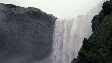 Wide-shot-of-massive-waterfall-pouring-down-water-over-the-precipice-of-doom