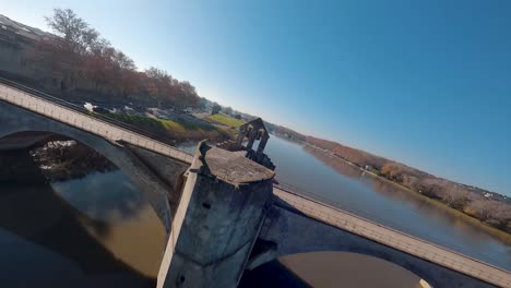 FPV-aerial-above-the-Rhône-river,-flying-over-bridge-and-following-cars-on-the-highway