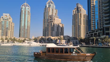Dubai-Marina-UAE,-Vintage-Touristic-Boat-and-Waterfront-Towers-and-Skyscrapers